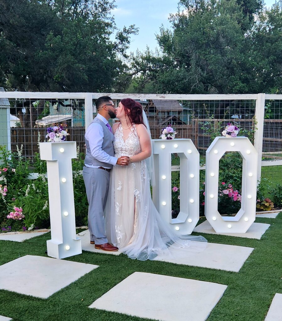 Happy couple celebrating their Austin Dripping Springs microwedding at Rose Haven, Dripping Springs Wedding Venue, wedding venue near Austin, Texas Hill Country Wedding Venue, Locally Owned Wedding Venue, Wedding Venue, Rustic, Elegant, wedding reception, austin elopement, texas honeymoon, cheap, budget, austin wedding venue, Texas hill country, texas honeymoon, austin wedding venue, cheap wedding venue, microwedding, elopement