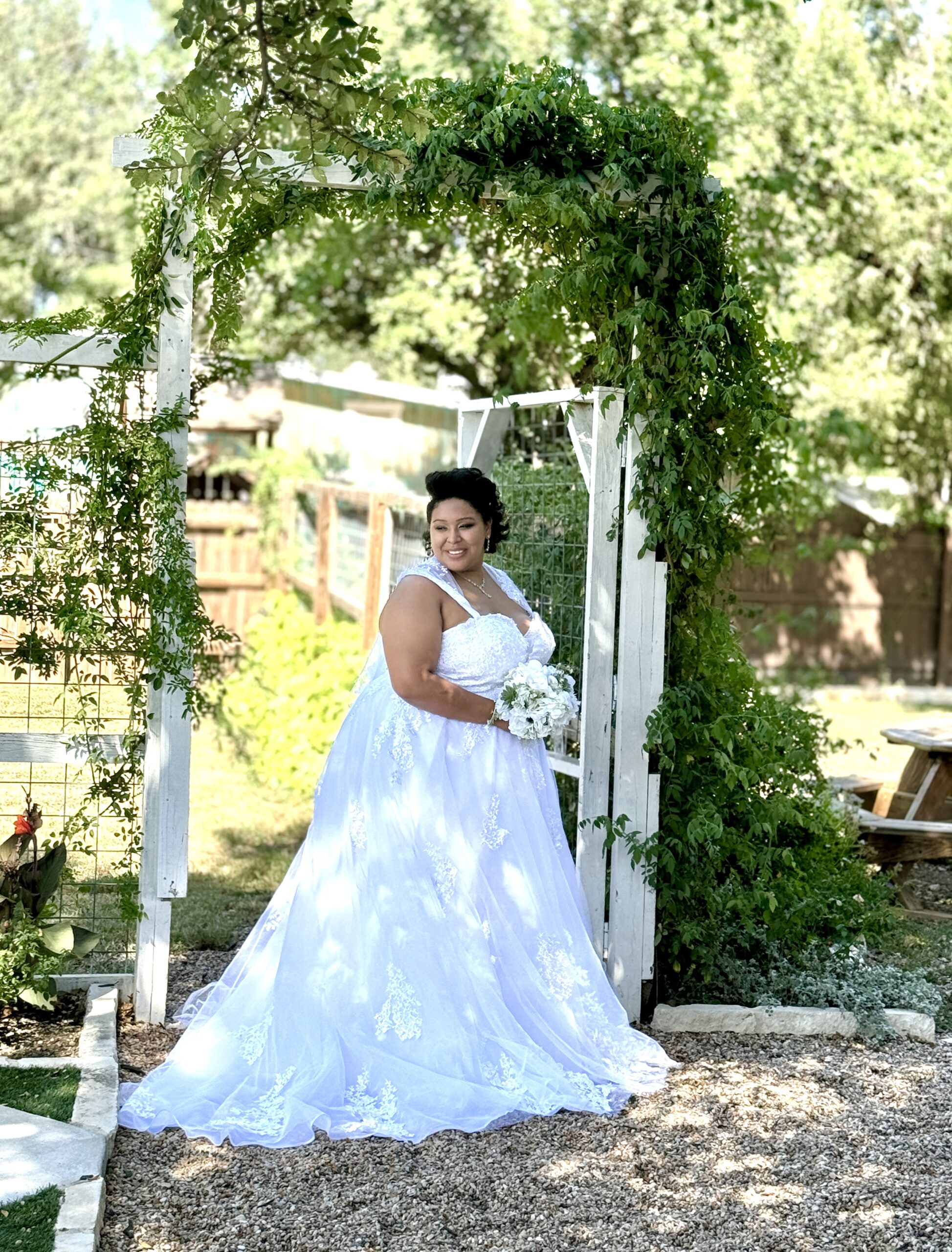 bride on antique rose veranda under rose arbor, austin wedding venue, dripping springs, texas hill country, affordable wedding venue