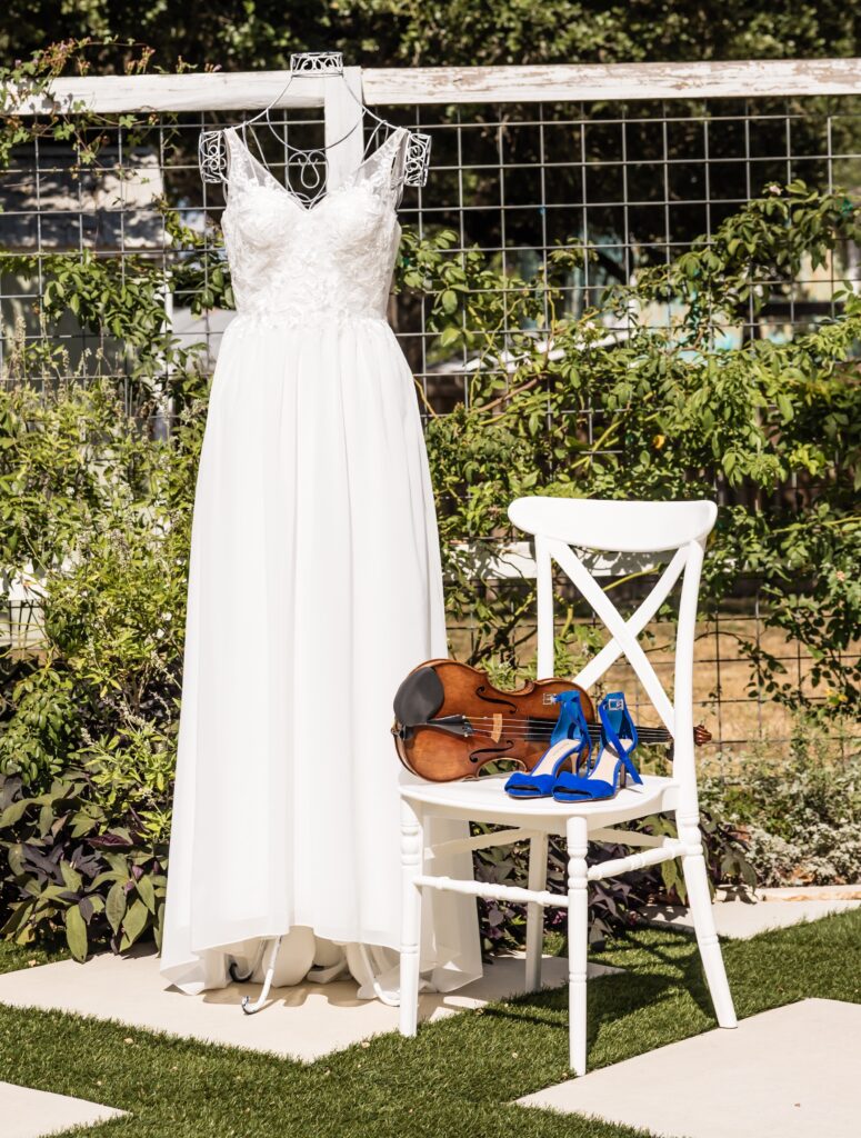 Wedding dress with violin and blue wedding shoes, Austin Texas wedding venue. Microweddings Austin Texas, Elopements Austin Texas, Weddings Dripping Springs Texas, Microweddings Dripping Springs Texas, Elopements Dripping Springs Texas,  Wedding Shower Austin, Bridal Shower Austin, Wedding Shower Dripping Springs, Bridal Shower Dripping Springs,