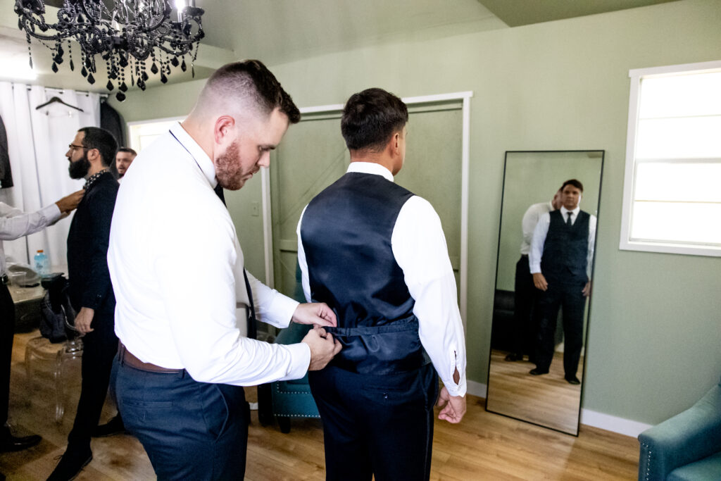 Groom getting ready in the Rose Cottage, austin texas wedding venue