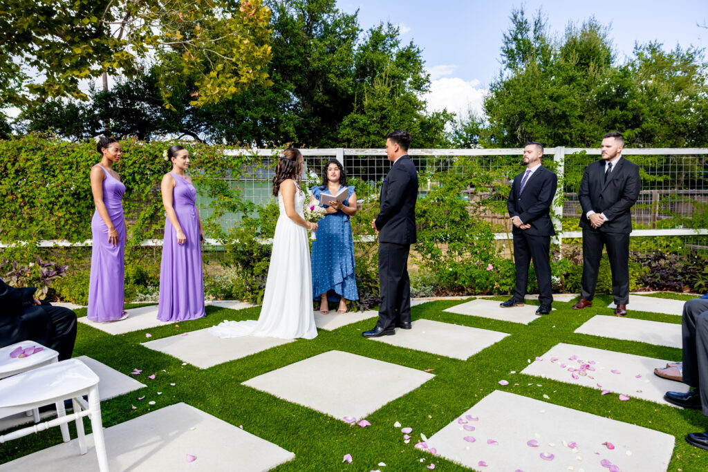 The beautiful wedding ceremony on the Antique Rose Veranda at austin wedding venue rose haven event venue