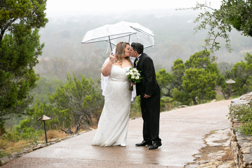 Couple kissing in the rain at Chapel Dulcinea Austin Wedding Chapel, Free Wedding Chapel, Texas Hill Country Wedding Chapel, Austin Wedding Venue, Austin Bride, Austin wedding reception, Hill Country chapel, Hill Country wedding venue, Dripping Springs Wedding Venue